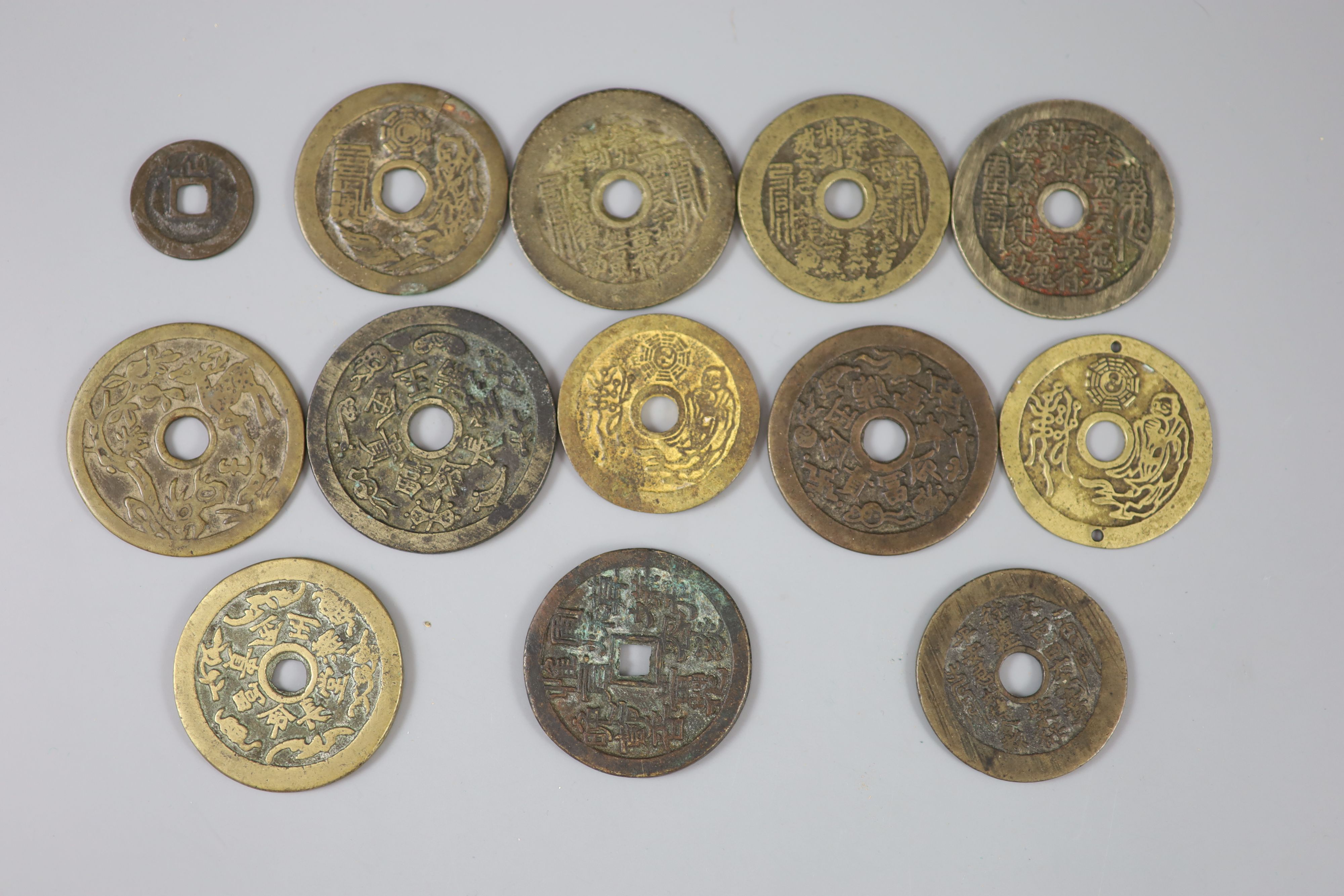 China, 12 cast bronze charms or amulets, Qing dynasty,